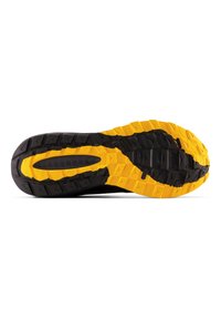 Suela de zapato con una combinación de colores negro y amarillo, que presenta un patrón de goma texturizada y formas geométricas para mejorar el agarre.