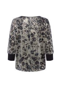 Paillettenoberteil mit Leopardenmuster in Silber und Schwarz. Mit kurzen Ärmeln und lockerer Passform. Strukturierte, glänzende Oberfläche.