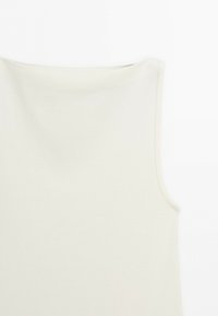 Sleeveless white ribbed top with a high neckline and smooth, fitted fabric.