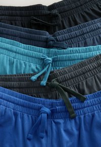 Five folded elastic waist shorts in black, dark blue, teal, charcoal, and royal blue, each with a tied drawstring at the center front.