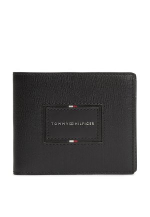 Czarny, teksturowany skórzany portfel z dwoma klapkami, ozdobiony naszywką w kształcie prostokąta z przeszyciami, z napisem "Tommy Hilfiger" oraz małymi czerwonymi, białymi i niebieskimi akcentami.