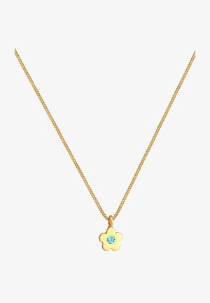 Collier en chaîne dorée avec un pendentif en forme de fleur doté d'une pierre précieuse bleue au centre. La chaîne présente un design torsadé classique.
