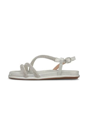 Silberne flache Sandale mit drei dünnen, mit Schmucksteinen besetzten Riemen und einem Knöchelriemen mit Schnallenverschluss, von der Seite auf weißem Hintergrund gezeigt.
