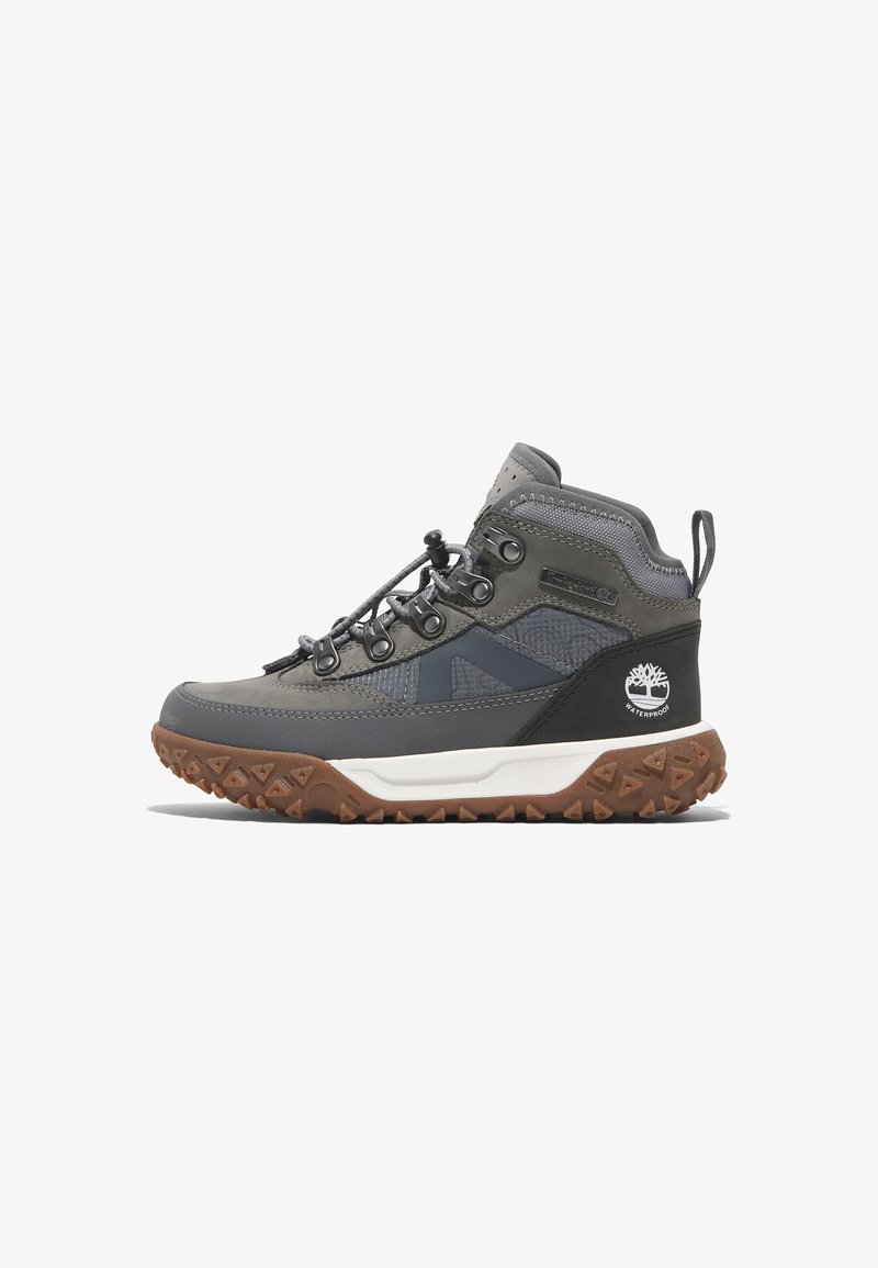 Gray hiking boots with a textured upper, waterproof design, contrasting black accents, and a rugged brown outsole with triangular treads.