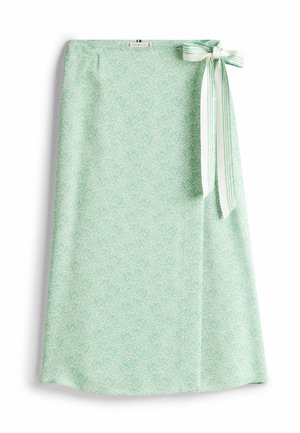 Heller grüner Rock mit einem durchgehenden weißen Wirbelmuster, seitlichem Schleifenakzent aus gestreiftem Stoff, glatte Textur, knielange Ausführung.