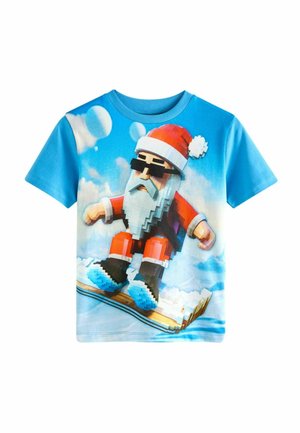 Blaues T-Shirt mit kurzen Ärmeln, das einen pixelierten Weihnachtsmann in einem roten Anzug beim Snowboarden zeigt, mit einem weißen Bart und Sonnenbrille vor einem Wolkenhintergrund.