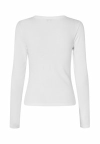 Long-sleeve white top made from ribbed fabric, featuring a round neckline and a fitted design with seamless construction on the back.