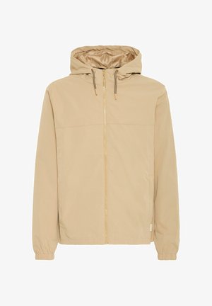 Beige hettejakke med glidelås laget av glatt stoff. Har elastiske mansjetter og et enkelt design, med snorer på hetta for justering.