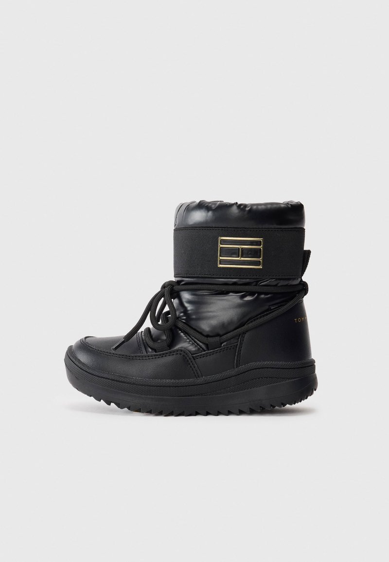 Black waterproof boots with a puffy upper, textured finish, adjustable laces, and a ridged sole. Features a gold accent on the side.