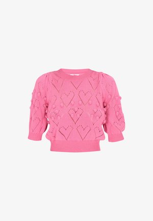 Pink knitted sweater featuring puff sleeves, heart-shaped cutouts, and textured pom-pom accents. Fitted hemline with ribbed trim.
