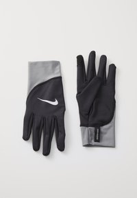 Sorte og grå Nike handsker med en tætsiddende design, glat tekstur og et hvidt logo på bagsiden. Har en fingertip, der er kompatibel med touchskærm.