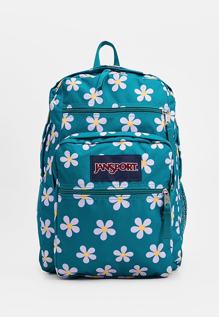 Mochila Jansport color teal con patrón de margaritas blancas y amarillas, bolsillos con cremallera en la parte delantera y superior, y un asa en la parte superior.