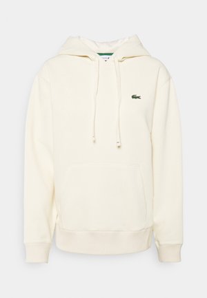 Sweat à capuche blanc cassé avec poche avant, cordon de serrage à la capuche, poignets et ourlet côtelés, et petit logo crocodile vert sur la poitrine.