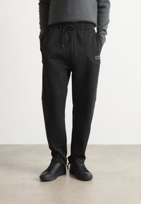 HUGO NIPIPEPANT - Tracksuit bottoms - black