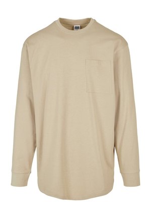 Beige langslav T-shirt gemaakt van katoen. Heeft een ronde hals, een linkse borstzak en een standaard snit met gevoerde mouwen.