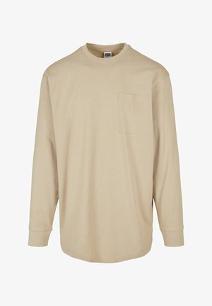 Beżowa, długosleeve koszulka T-shirt z bawełny. Posiada okrągły dekolt, kieszeń na lewej piersi oraz standardowy krój z podszewką przy mankietach.