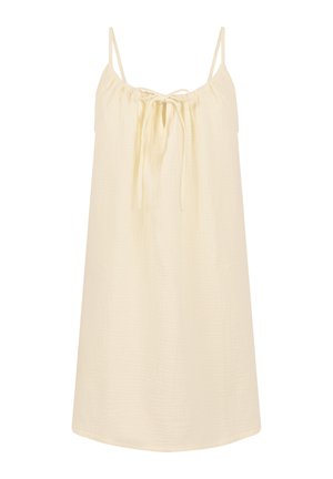 Mouwloze lichtbeige jurk met dunne bandjes en een strikdetail aan de voorkant, met een losse, ontspannen pasvorm.