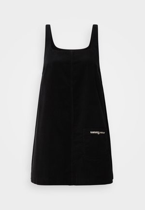 Must mustriga mustri kleit, millel on laiad õlapaelad, ruudukujuline dekoltee ja eest tasku, kuhu on linditud "tommy jeans" logo.