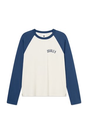 Pikad varrukadega T-särk, helekreemjas kere ja mereväe sinised raglaanvastrid. Rinnaesisel väikse sinise "DOUBLE A" logoga ja äärel küljesäärtega.