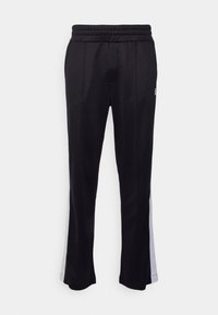 Černé sportovní kalhoty s texturovanou tkaninou, se strečovým pasem a světle šedými bočními pruhy. Přizpůsobený design, rovný střih.