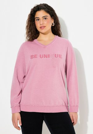 Rosa Langarm-V-Ausschnitt-Sweatshirt mit dem gestickten Text "SEI EINZIGARTIG". Verfügt über eine lockere Passform und ausgefranste Saumdetails.