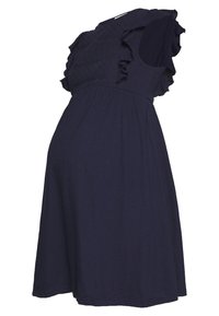 Sukienka dla ciężarnych w ciemnym granacie, z falbaniastym, teksturowanym ramieniem, dopasowanym tułowiem i zwiewnym dołem. Miękka, lekka tkanina z elastanem.