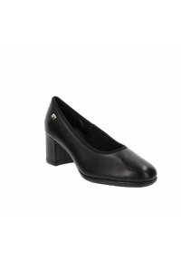 Scarpa pump nera in pelle con punta arrotondata, tacco basso a blocco, superficie liscia e un piccolo dettaglio in oro sul lato.