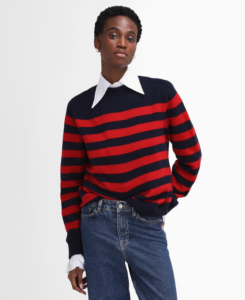 Gestreifter Pullover in Rot und Marineblau aus weichem Strickstoff, mit Rundhalsausschnitt und gerippten Bündchen, kombiniert mit blauen, hochgeschnittenen Jeans.