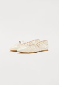 Ballerines avec un bout et un talon en vernis beige brillant, une tige en maille florale décorative et une fine sangle avec une boucle dorée.
