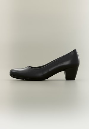 Escarpin en cuir noir pour femme, à bout arrondi et à talon bloc bas, présenté de profil sur un fond uni.