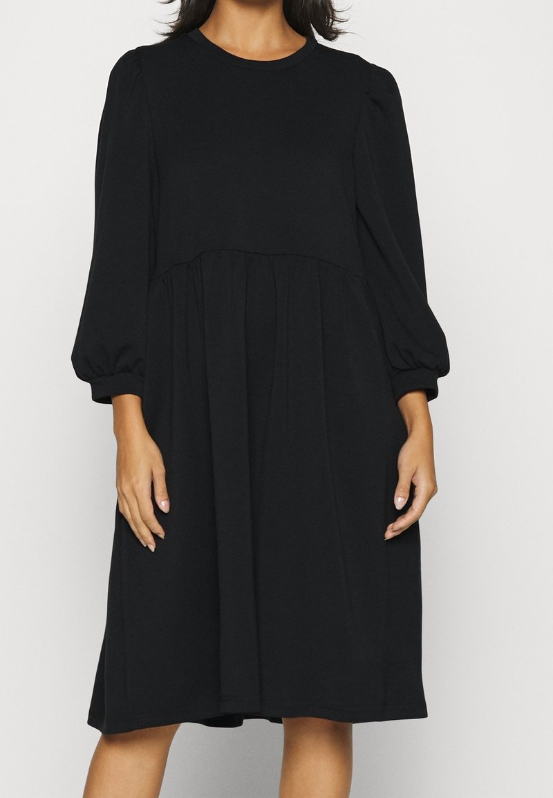 Black dress made of soft fabric, featuring a round neckline, long puff sleeves, and a loose-fit A-line silhouette with a gathered waist.