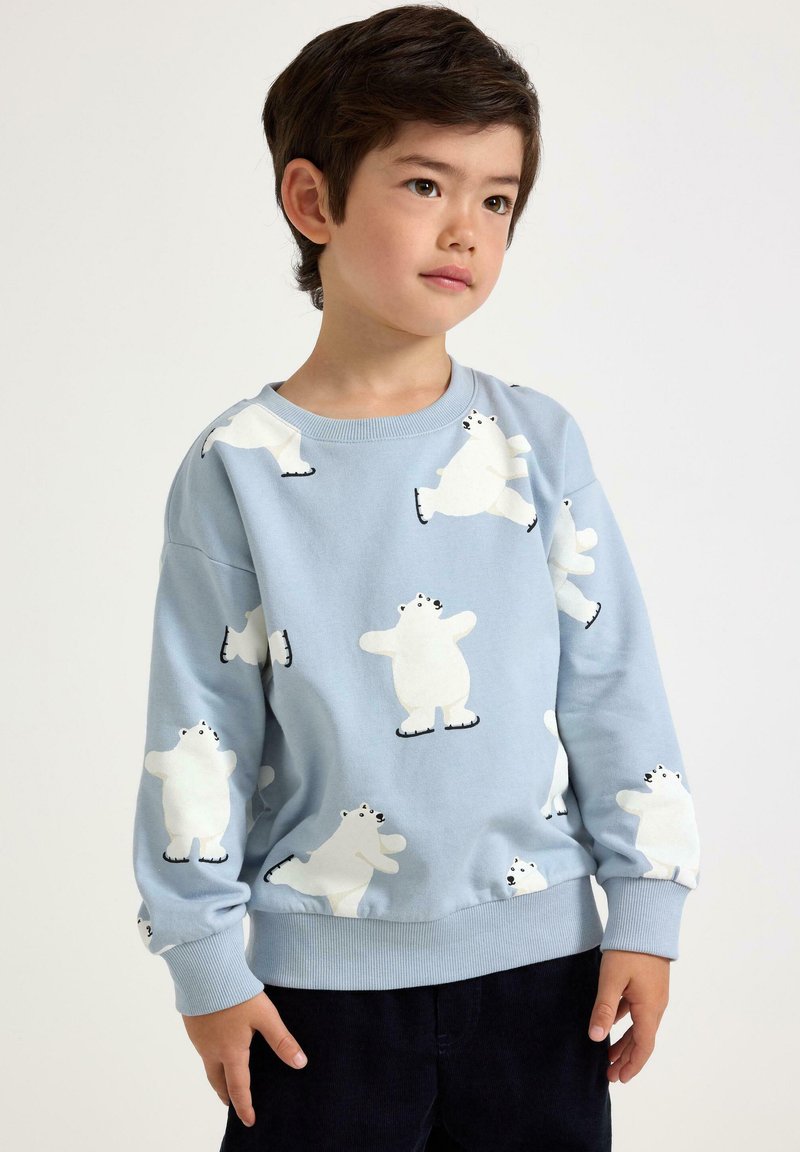 Hellblaues Sweatshirt mit weißen Illustrationen von Eisbären und schwarzen Akzenten. Weicher Stoff mit gerippten Bündchen und Saum.