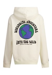 Cream-colored hoodie featuring a large graphic of Earth, with text reading "Worldwide Adventure" and "Into the Wild" in bold black letters.