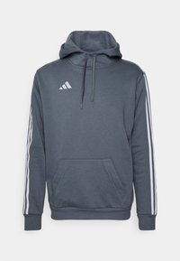 Hoodie gris avec une poche frontale, capuche ajustable avec cordon de serrage, et rayures blanches Adidas le long des manches. Tissu doux, coupe décontractée.