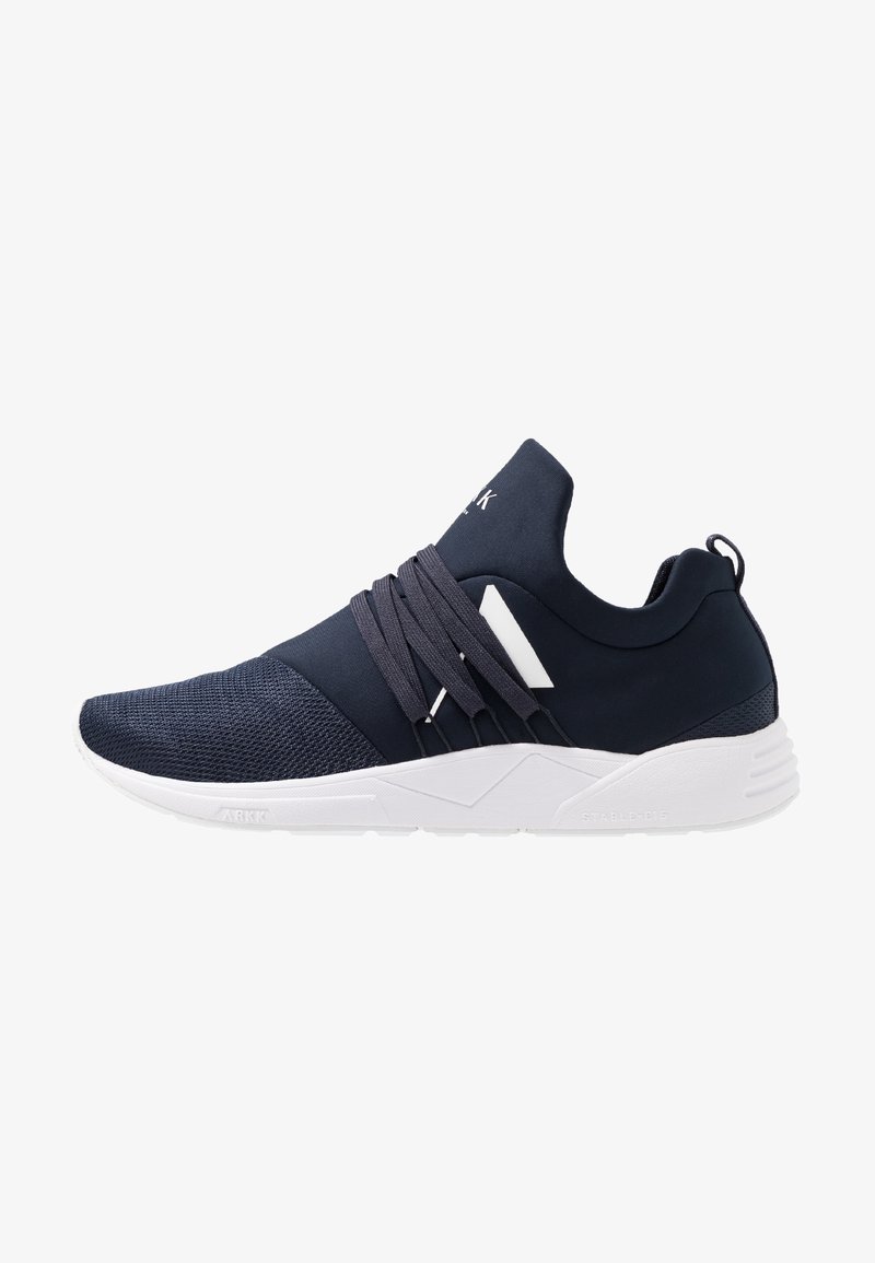 Navy sneaker with a mesh and smooth fabric upper, elastic laces, a white midsole, and textured sole; minimalist design with angular accents.