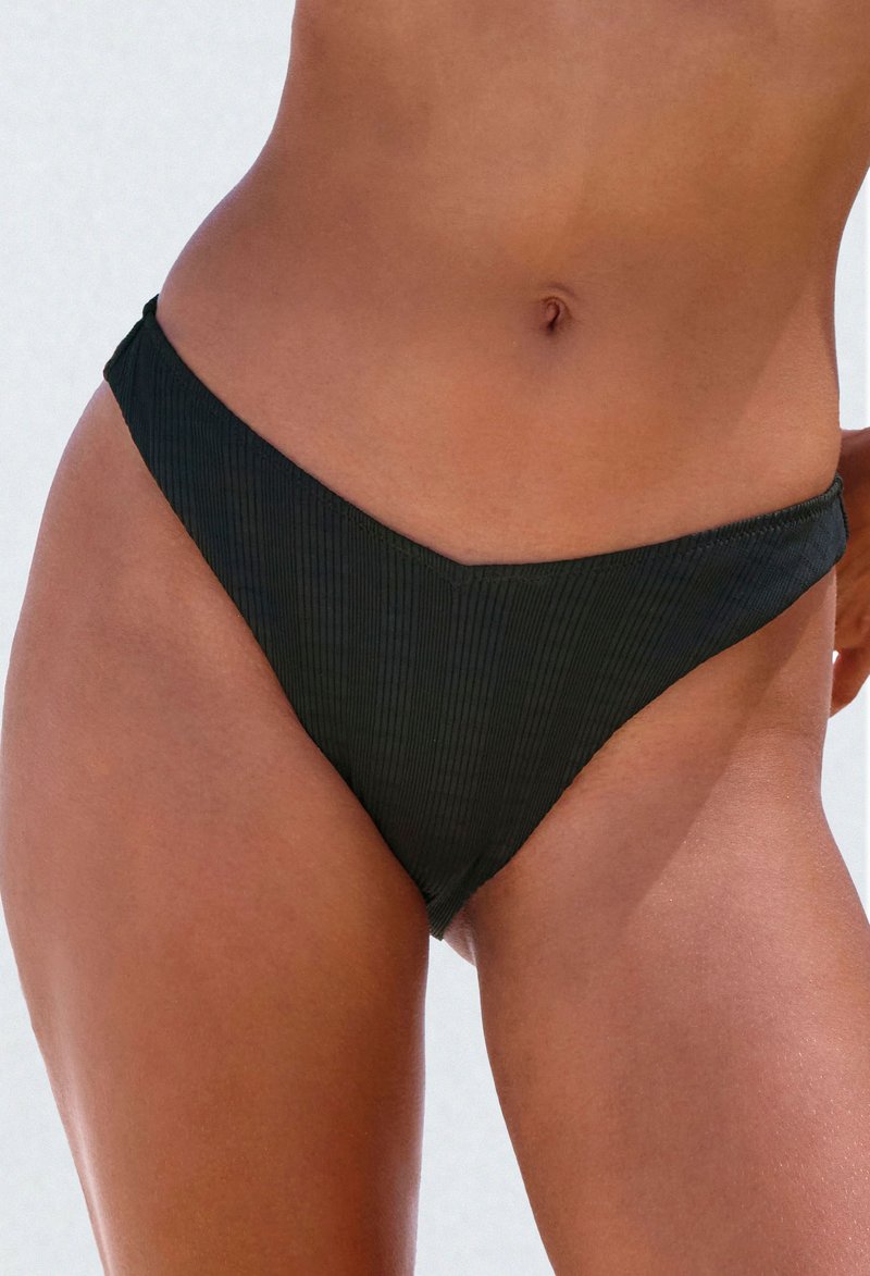 Black ribbed bikini bottom featuring a v-shaped front, low-rise design, and thin side straps. Textured fabric adds subtle dimension.