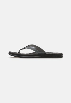 Must have kingadega rihmadega flip-flop-sandaal musta värvi, tekstuuriga jalatoe, kummist tallaga ja sünteetilisest materjalist rihmadega, millel on kontrastsed õmblused ja logo detail.