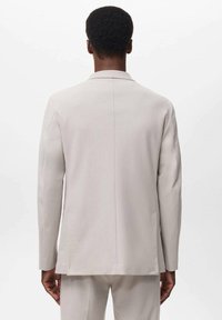 Light grey suit jacket made of smooth fabric. Features a notched collar, long sleeves, and a straight cut with no visible pockets.