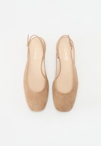 Beige suede slingback shoes with a rounded toe and a small heel. The design includes an ankle strap and gold hardware accents.