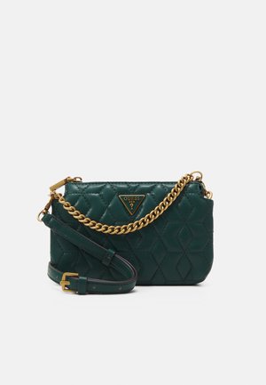 Dunkelgrüne gesteppte Umhängetasche mit goldfarbener Kettendetail und verstellbarem Riemen, mit einem dreieckigen Guess-Logo auf der Vorderseite.