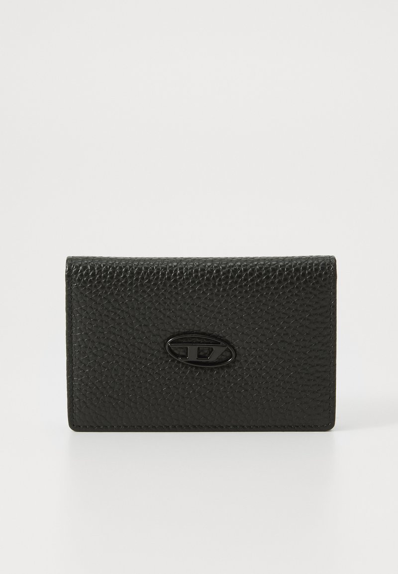 Black textured leather cardholder with a smooth oval logo accent on the front. Compact rectangular shape, clean lines, and minimalistic design.