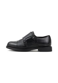 Czarne skórzane buty typu monk strap z podwójnymi klamrami, gładką teksturą, okrągłym czubkiem i lekko podniesioną czarną gumową podeszwą.