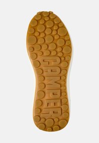 Rubber shoe sole featuring a textured pattern of circular bumps in shades of brown with "CAMPER" embossed prominently in the center.