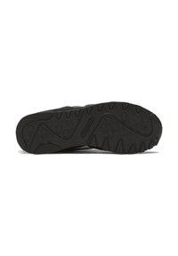 Black athletic shoe sole with a textured rubber surface, featuring a multi-directional tread pattern and recessed logo detail.