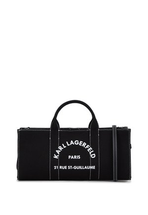 Black canvas bag featuring white logo text, dual top handles, and detachable shoulder strap. Contrast stitching adds visual interest.