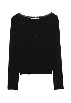 Fekete, hosszú ujjú felső V-nyakkivágással, melynél csipkés díszítés fut a nyak mentén, és rövidített szegéllyel rendelkezik. Puha, rugalmas anyagból készült.