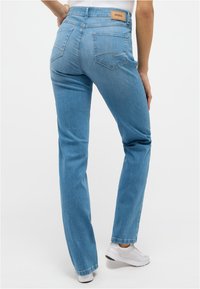 Light blue denim jeans with a straight leg design, featuring back pockets, a branded label, and a smooth texture.