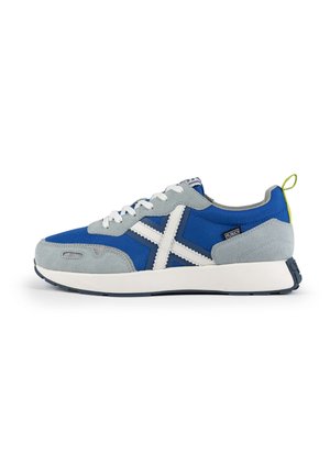 Blue and gray sneaker with a fabric and suede upper, white accents, a rounded toe, and a textured sole. Features a yellow pull tab on the heel.