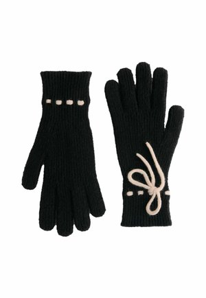 Svarta stickade handskar med ribbad struktur, prydda med vita prickar längs handleden och en dekorativ rosett av vitt snöre.