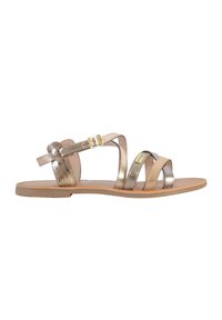 Sandalias de tiras con acentos metálicos en oro y plata, con suela plana, hebilla ajustable en el tobillo y plantilla de color beige neutro.